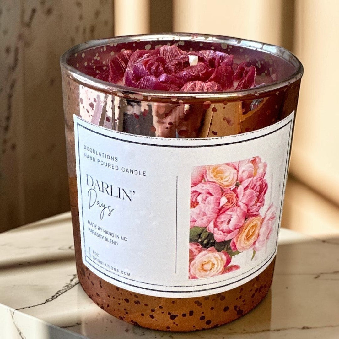Darlin' Days floral candle in a rose gold mercury glass jar with pink and cream rose decorations.
