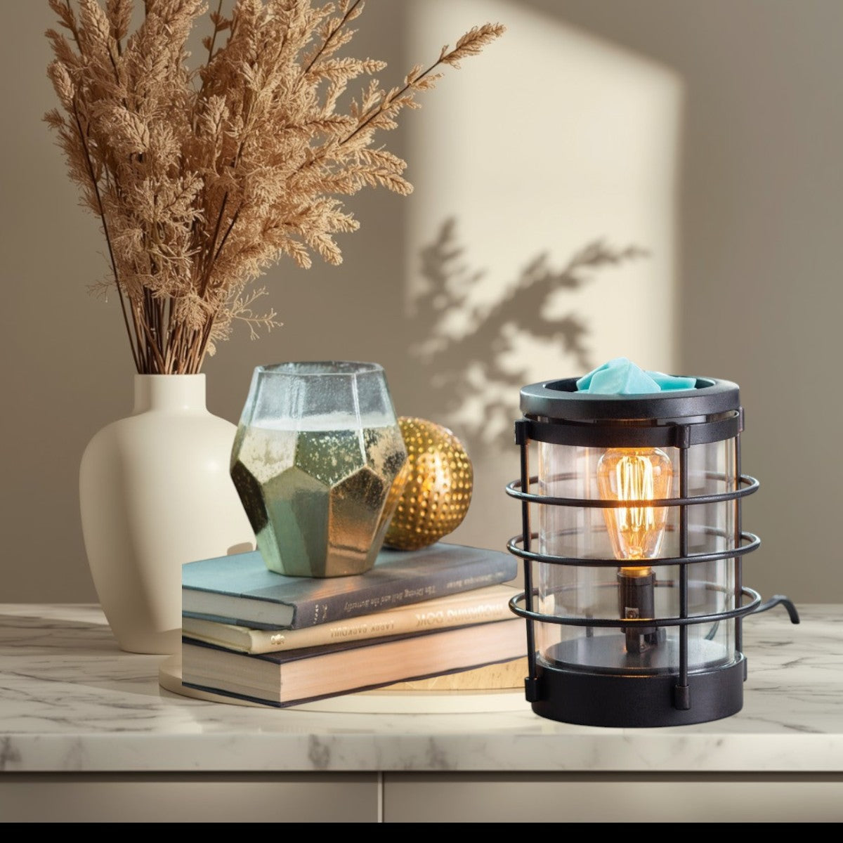 Vintage Bulb Illumination wax warmer with green wax melts and a warm glowing bulb.