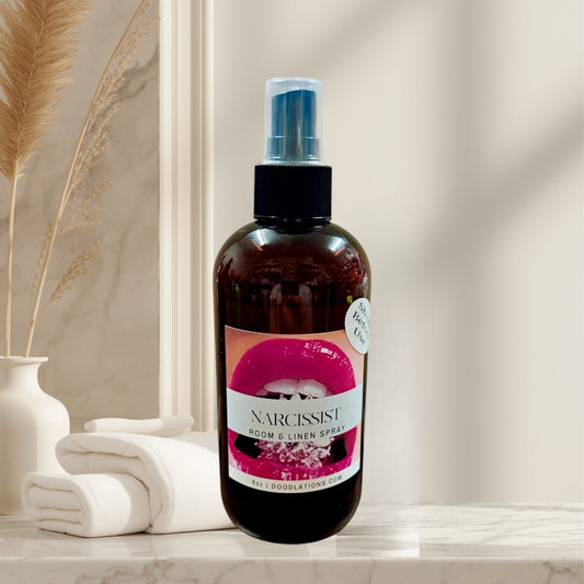Narcissist room and linen spray in a brown glass bottle with a pink lips label. Fruity-floral scent.