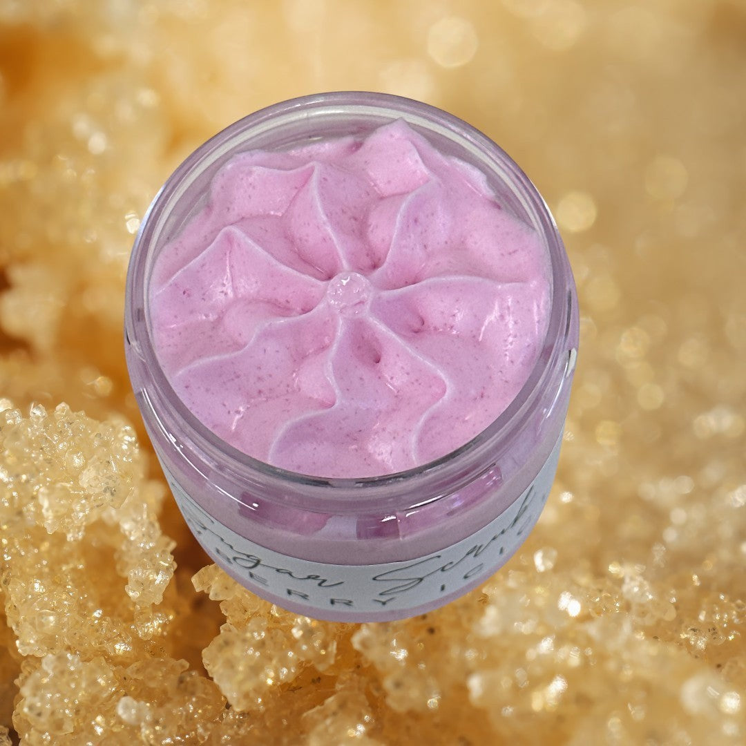 Snowberry Icicles sugar scrub in a clear jar with a black lid. Pink exfoliating body scrub.