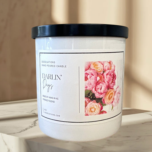 Darlin' Days hand-poured soy blend candle with a floral label and black lid.