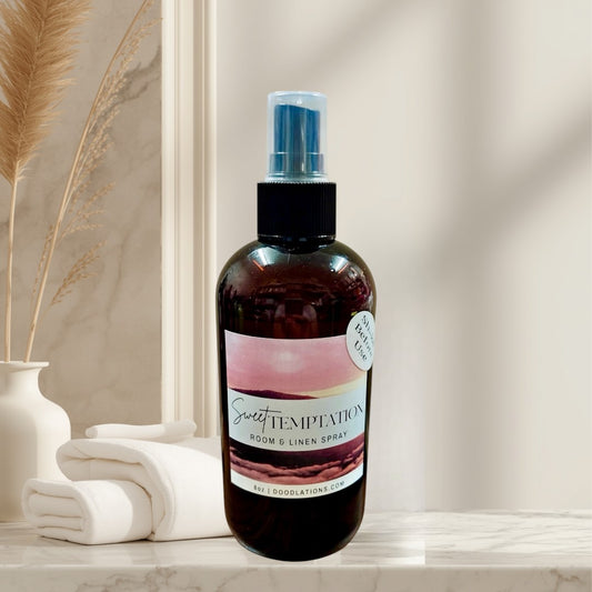Sweet Temptation room and linen spray in a dark amber bottle with a pink and white label.