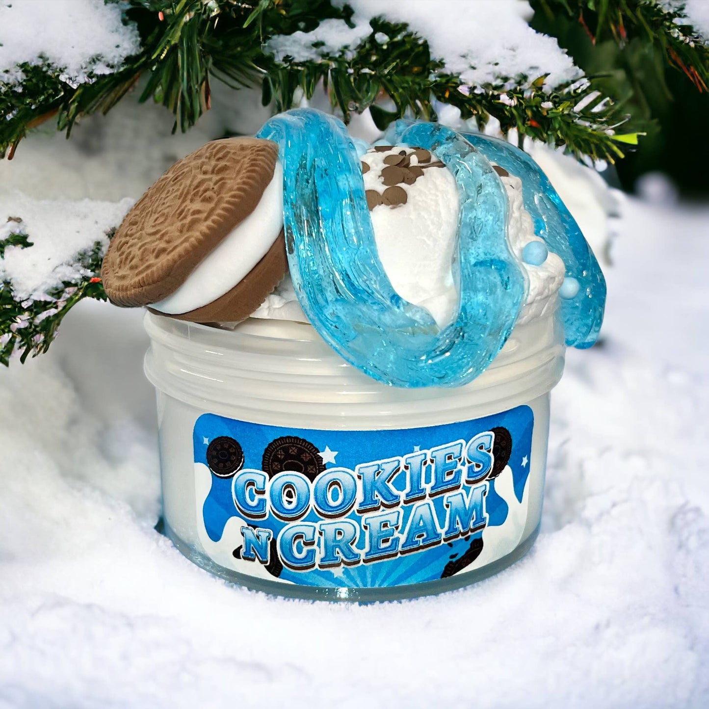 Jar of 'Cookies N Cream' ice cream with cookies on top, set against a snowy background.
