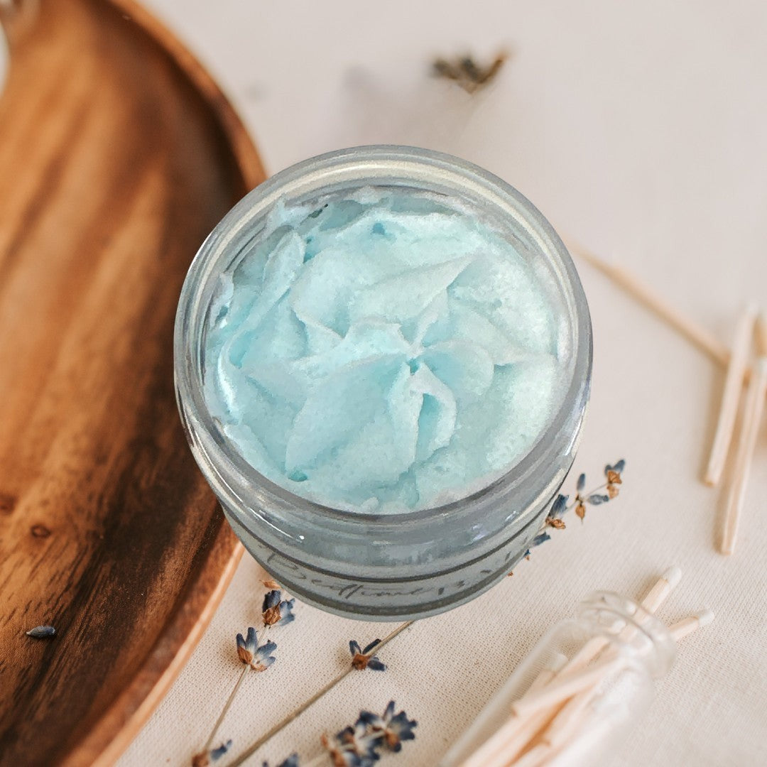 Bedtime Bath sugar scrub in a clear jar with a black lid, light blue marbled texture.