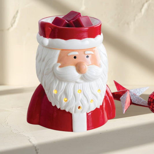 St. Nick fragrance warmer shaped like Santa Claus, with red suit and white beard, glowing warmly.