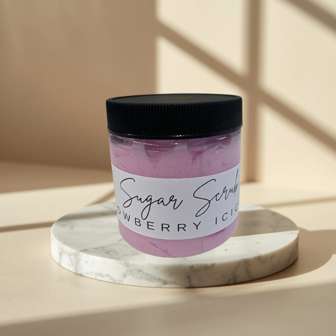 Sugar Scrub in Snowberry Icicles scent, a pink whipped body scrub in a clear jar.