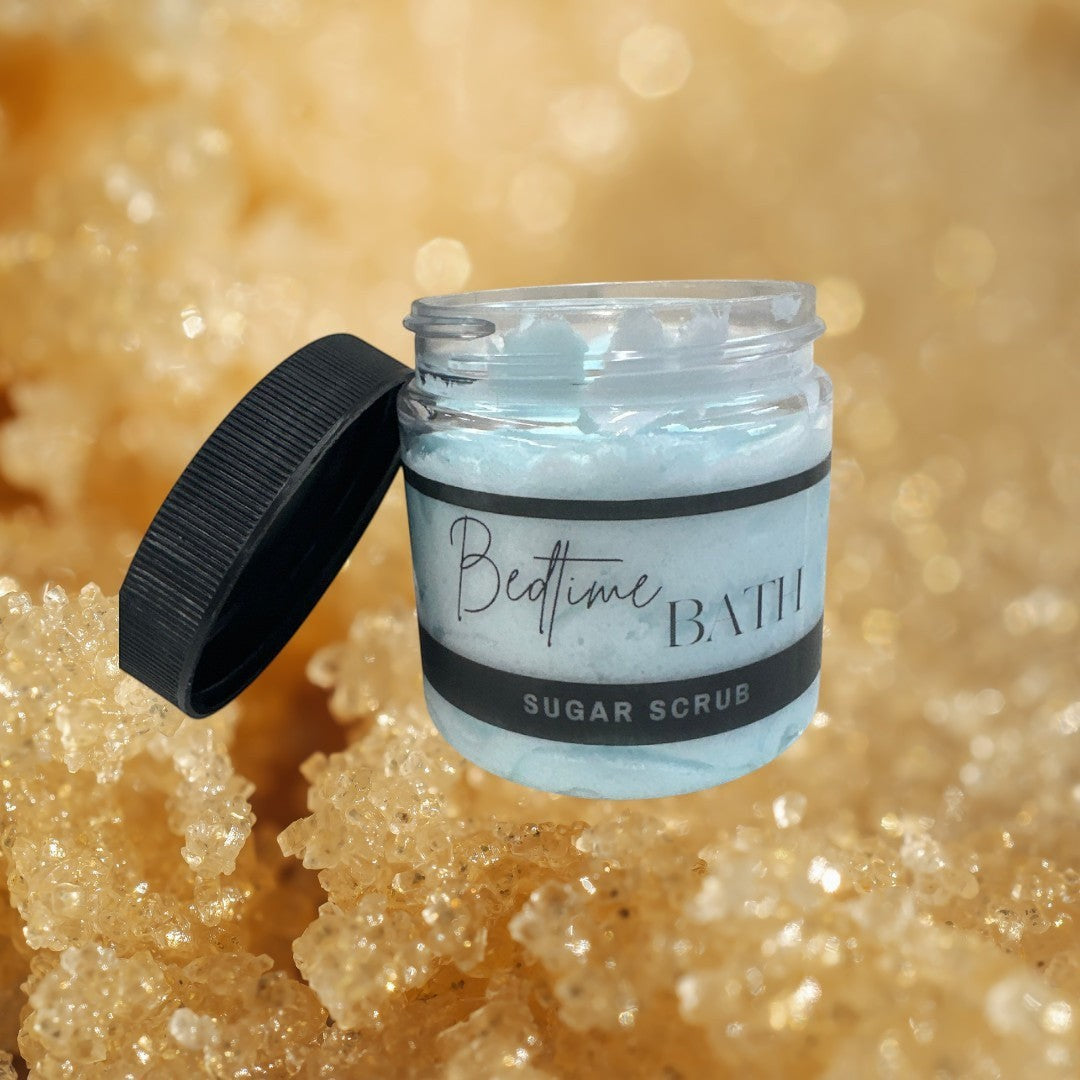 Bedtime Bath sugar scrub in a clear jar with a black lid, light blue marbled texture.