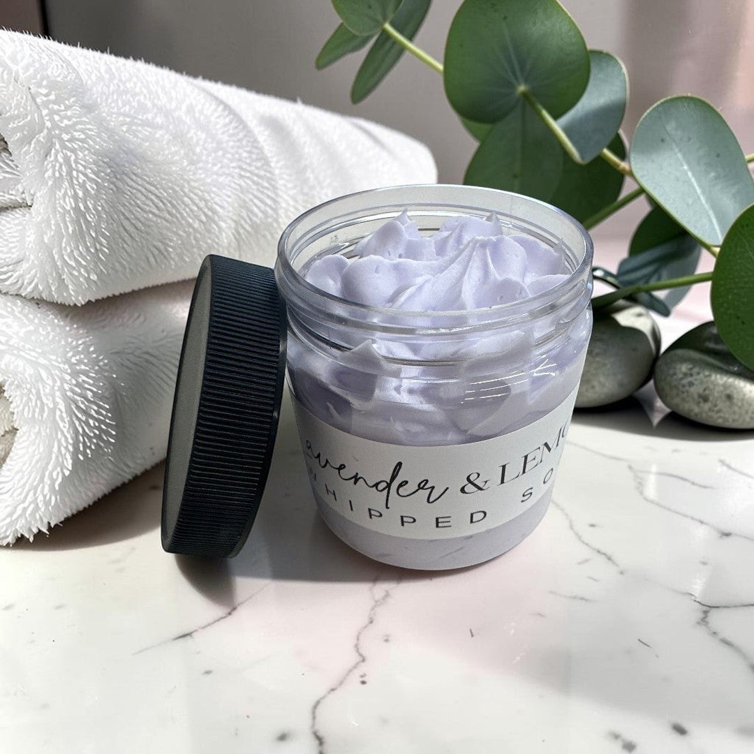 lavender and lemon whipped body soap in a 4oz clear jar with a black lid.