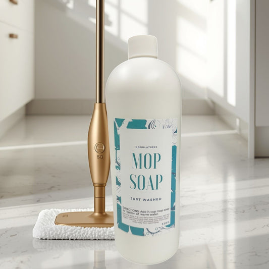 Mop Soap, concentrated floor cleaner in a white bottle with a teal floral label, next to a gold mop.