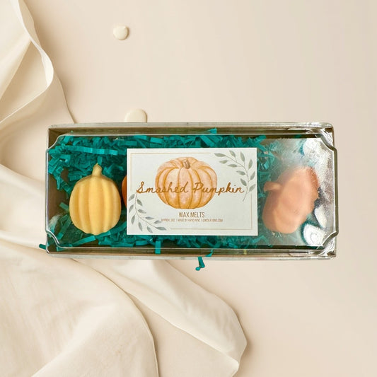 Smashed Pumpkin wax melts in pumpkin shapes, orange and yellow, with fall fragrance.