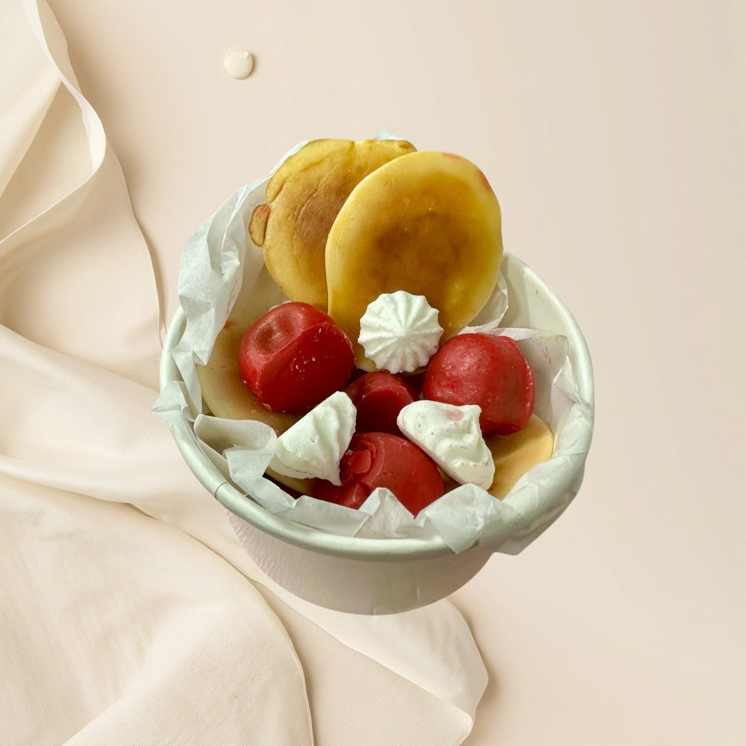 Cherry Pancake wax melts shaped like pancakes, cherries, and meringues in a pink bowl.