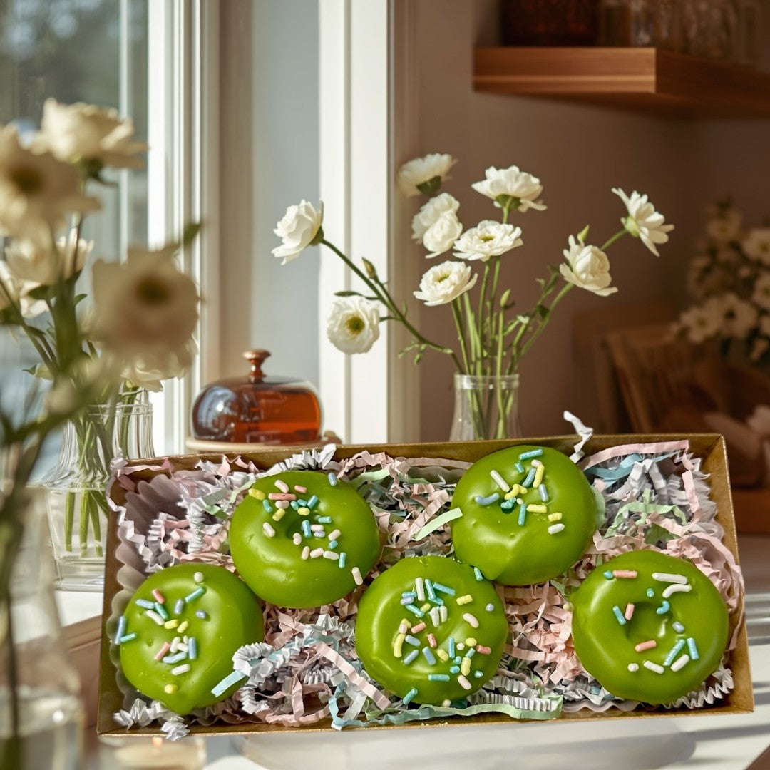 Key Lime Donut wax melts are bright green and shaped like donuts with colorful sprinkles.
