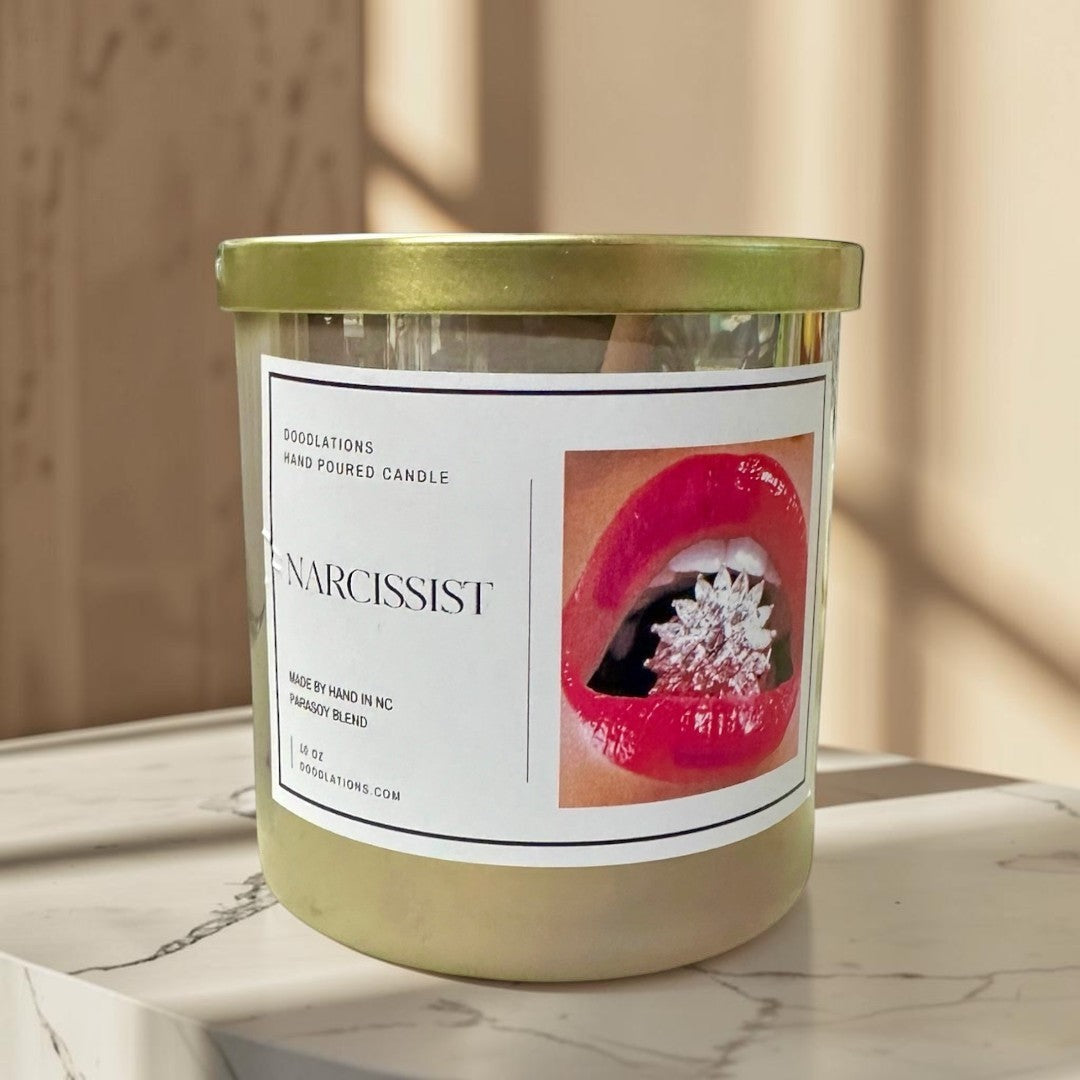 Doodlations Coffee Bar & Boutique Narcissist luxury hand-poured soy blend candle with a bold floral-fruity scent.