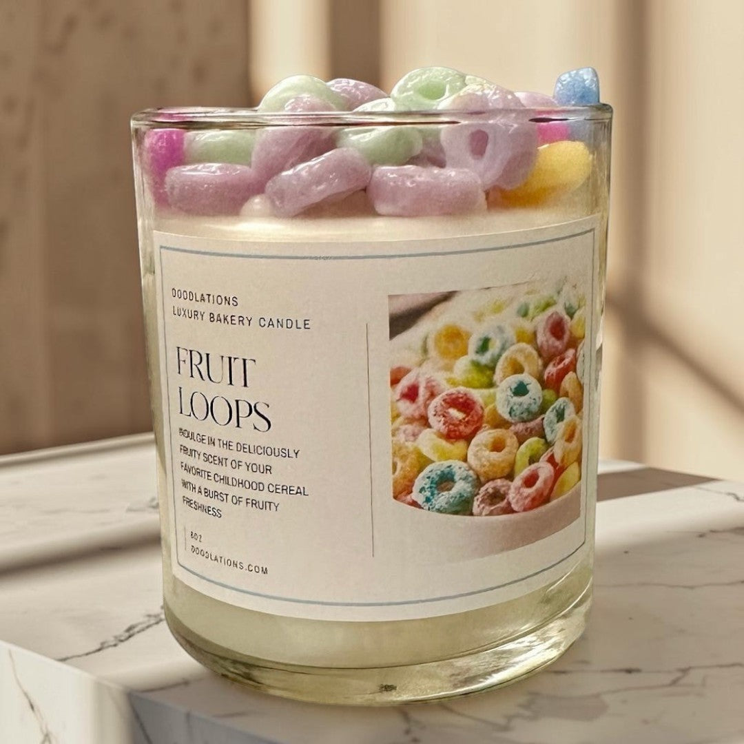 Fruit Loops luxury bakery candle in a glass jar, topped with colorful cereal pieces. Fruity scent.