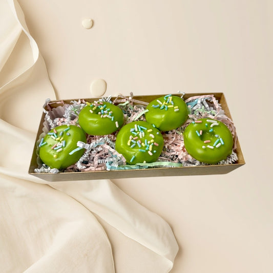 Key Lime Donut wax melts are bright green shaped like donuts with colorful sprinkles.