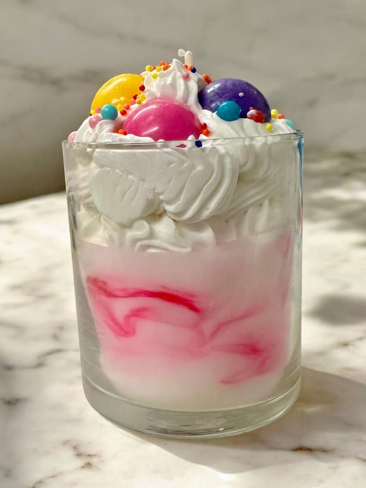 Bubblegum candle with whipped wax topping, candy sprinkles, and a colorful gumball wrapper design.
