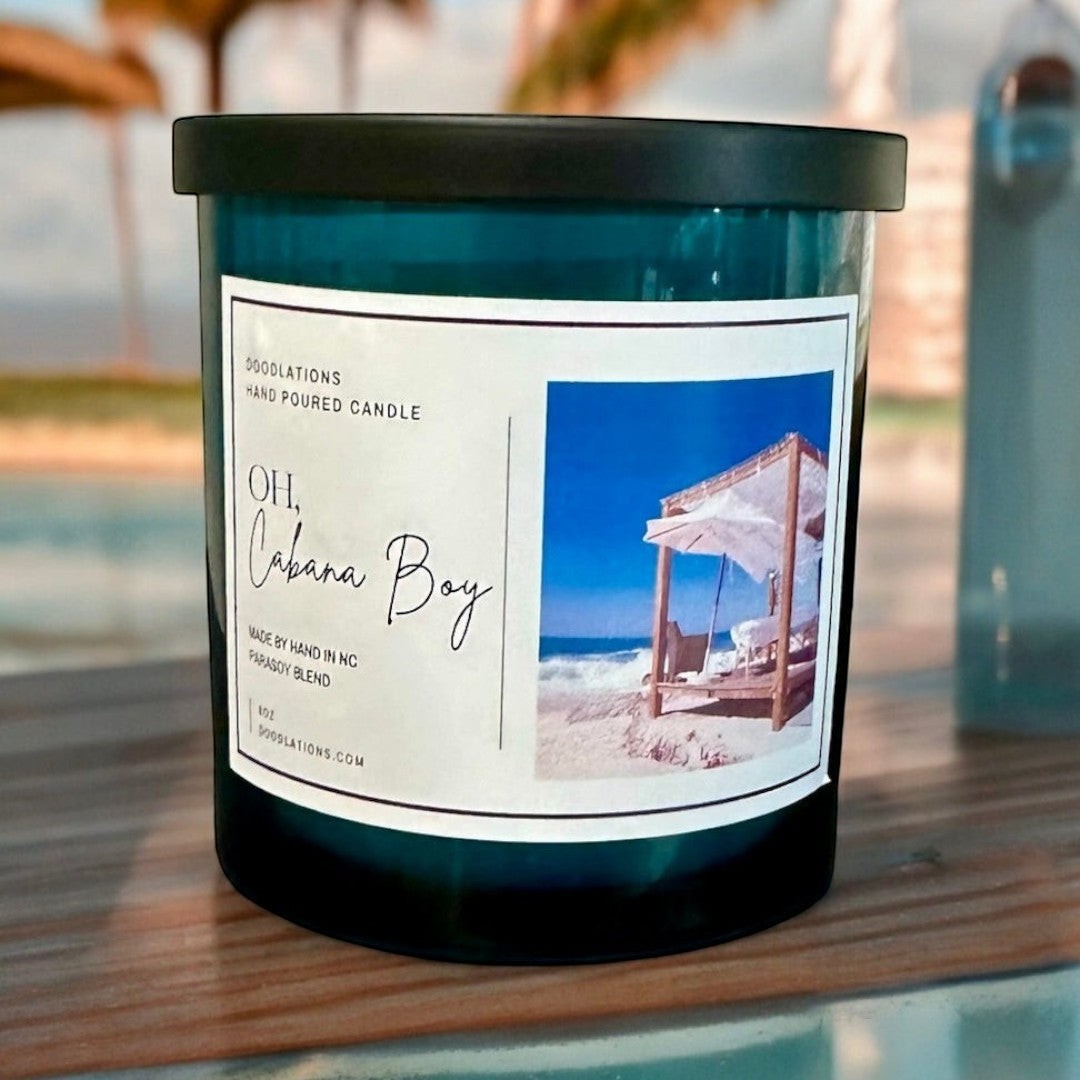 Doodlations Coffee Bar & Boutique Oh Cabana Boy luxury hand-poured candle with tropical beach scene label.
