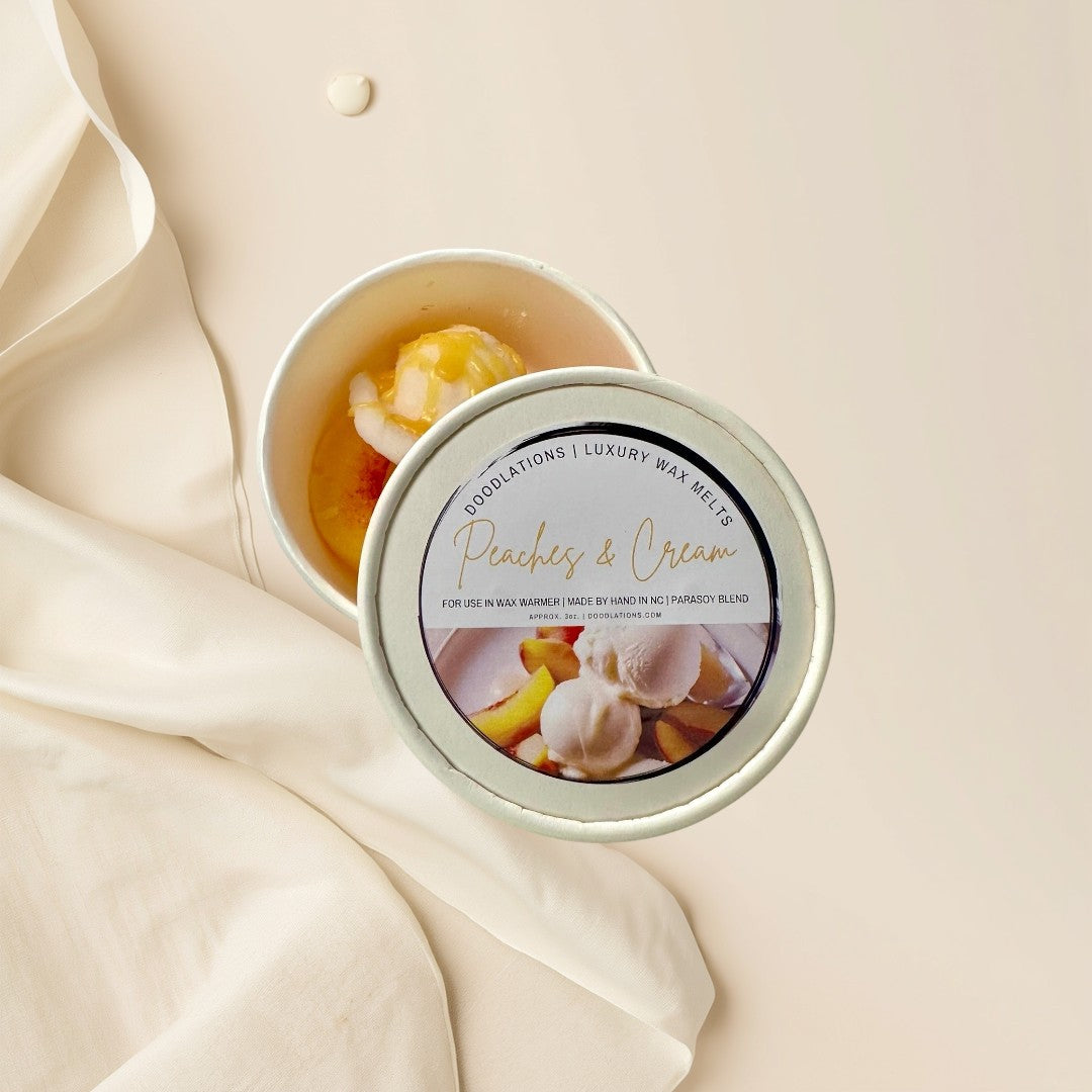 Peaches and Cream wax melts shaped like ice cream with peach slices and syrup.
