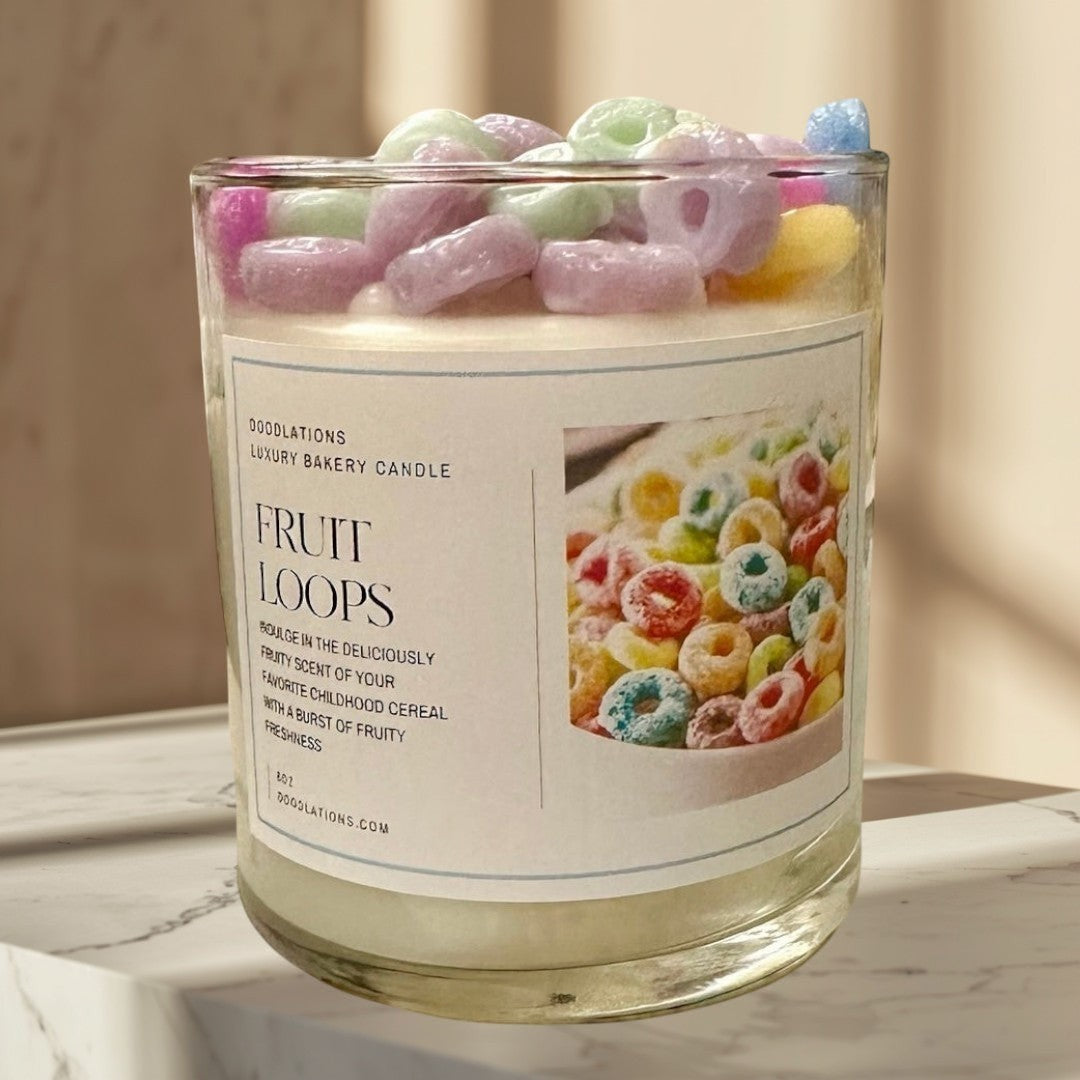 Fruit Loops luxury bakery candle in a glass jar, topped with colorful cereal pieces. Fruity scent.