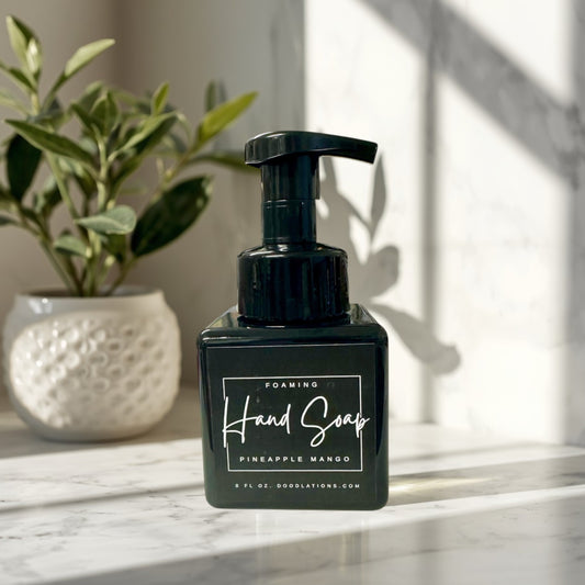 Pineapple Mango Foaming Hand Soap in a black square bottle with a black pump dispenser. Tropical scent.