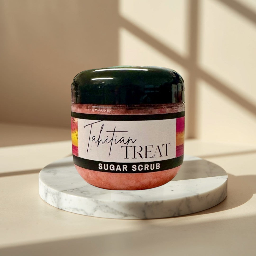 Tahitian Treat Sugar Scrub, pink exfoliating body scrub in a clear jar with a black lid.