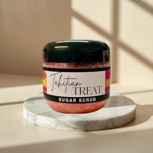 Tahitian Treat Sugar Scrub, pink exfoliating body scrub in a clear jar with a black lid.