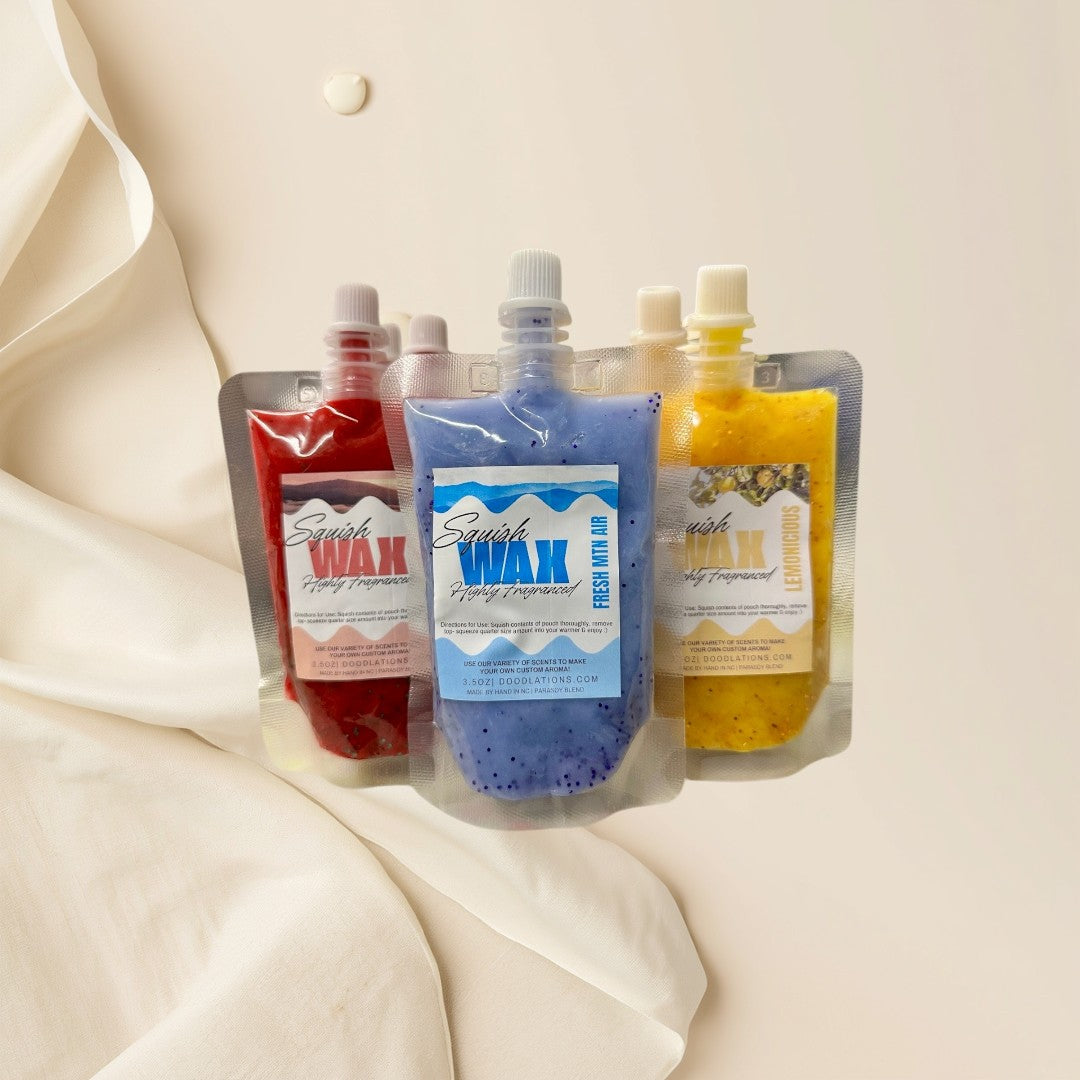 Squish Wax Melts in red, blue, and yellow pouches with glitter. Highly fragranced.