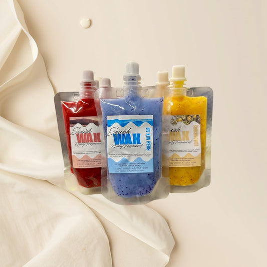 Squish Wax Melts in red, blue, and yellow pouches with glitter. Highly fragranced.
