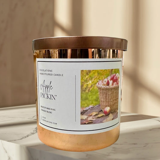 Apple Pickin' hand-poured soy blend candle in a copper vessel with a fall harvest label.