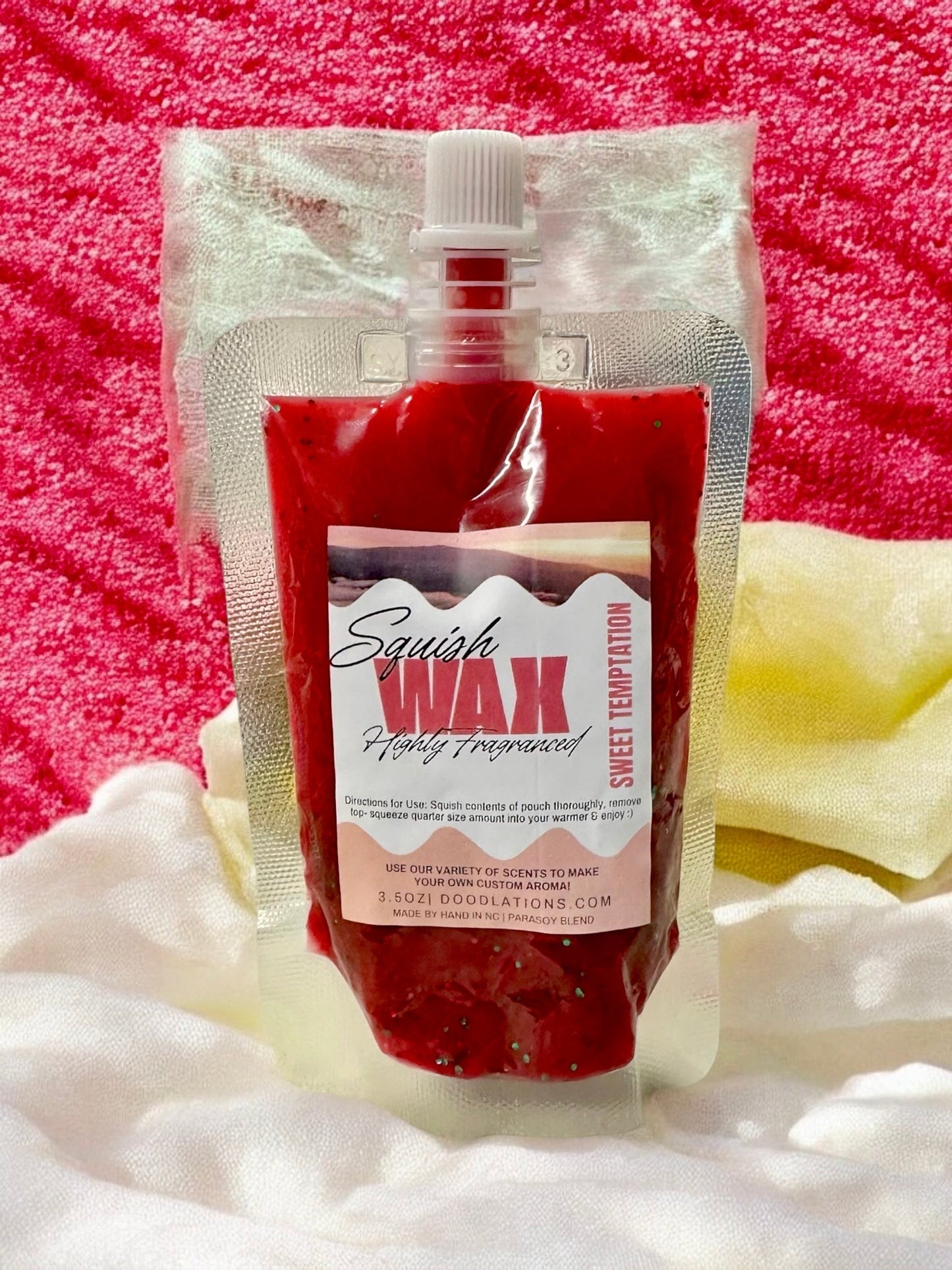 Squish Wax Melts in red, blue, and yellow pouches with glitter. Highly fragranced.