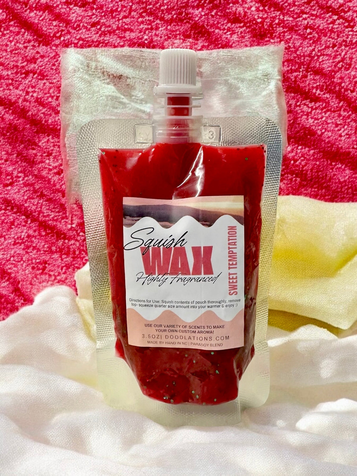 Squish Wax Melts in red, blue, and yellow pouches with glitter. Highly fragranced.