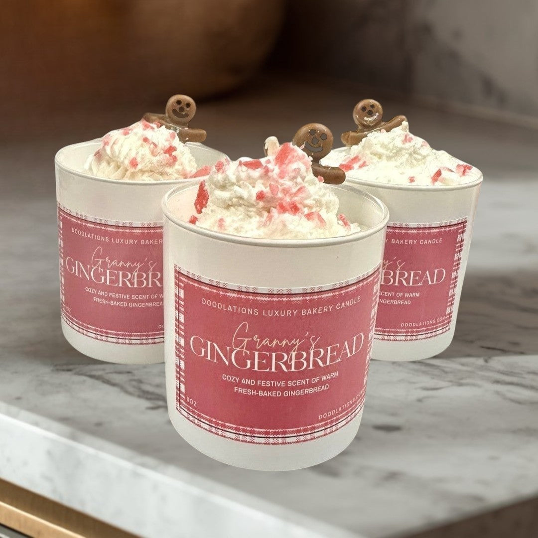 Christmas Gingerbread luxury bakery candle with whipped cream and gingerbread man topper.