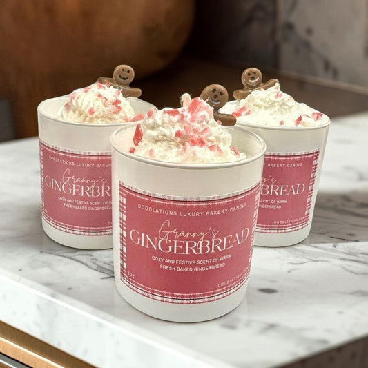 Christmas Gingerbread luxury bakery candle with whipped cream and gingerbread man topper.