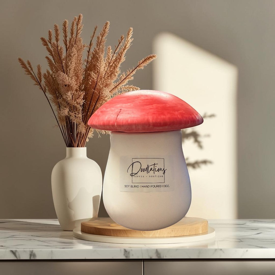 mushroom-shaped concrete candle with a red cap and white base, soy blend wax, salted honey scent.