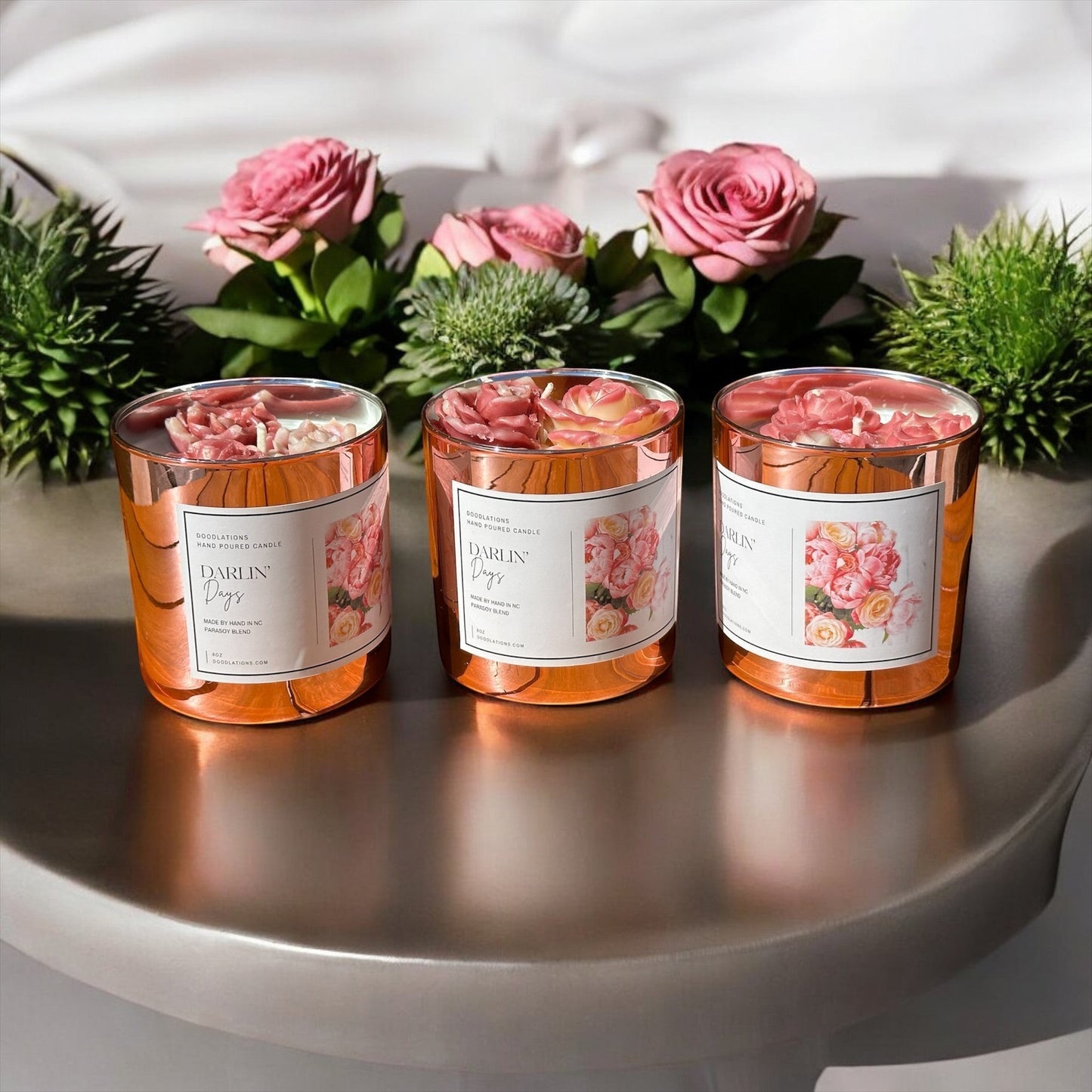 Darlin' Days floral candle in a rose gold mercury glass jar with pink and cream rose decorations.