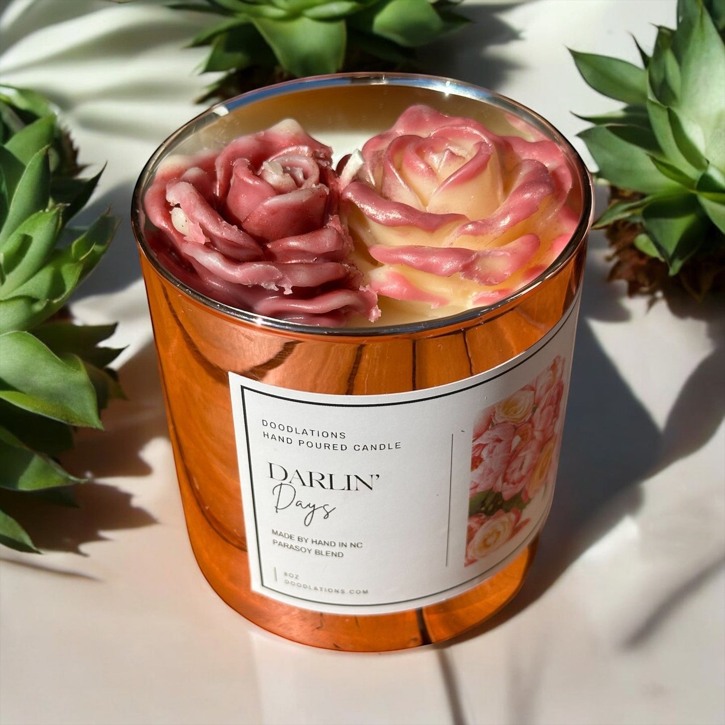 Doolations Darlin' Days floral candle in a rose gold mercury glass jar with pink and cream rose decorations.