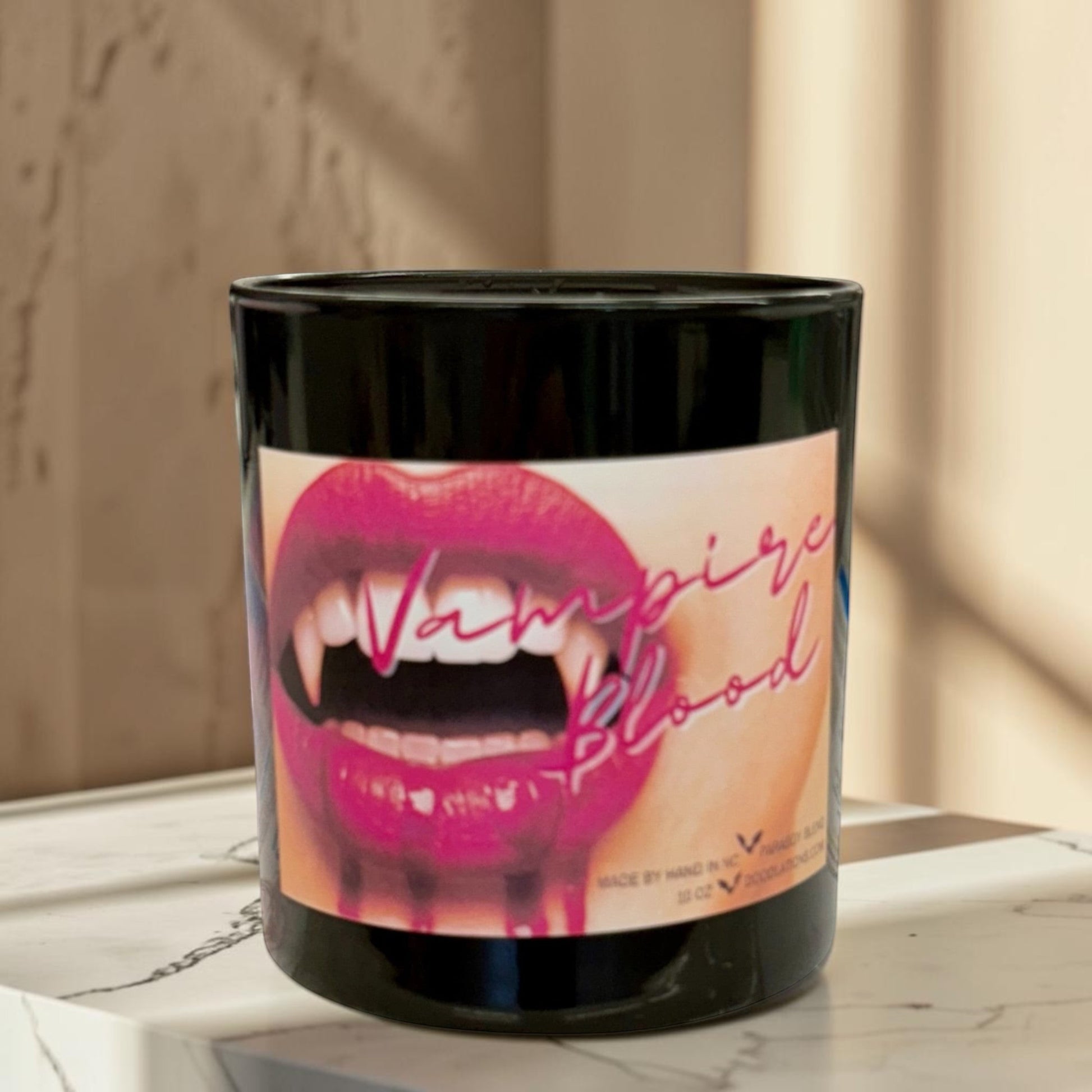 Doodlations Coffee Bar & Boutique Vampire Blood luxury candle with decorative wax fangs and bats. Bold berry, jasmine, amber scent.