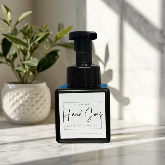 Sea Salt & Orchid foaming hand soap in a black square bottle with a white label.
