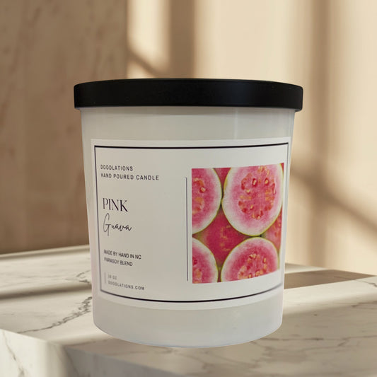 Doodlations Coffee Bar & Boutique Pink Guava hand-poured soy blend candle with a tropical beach background.