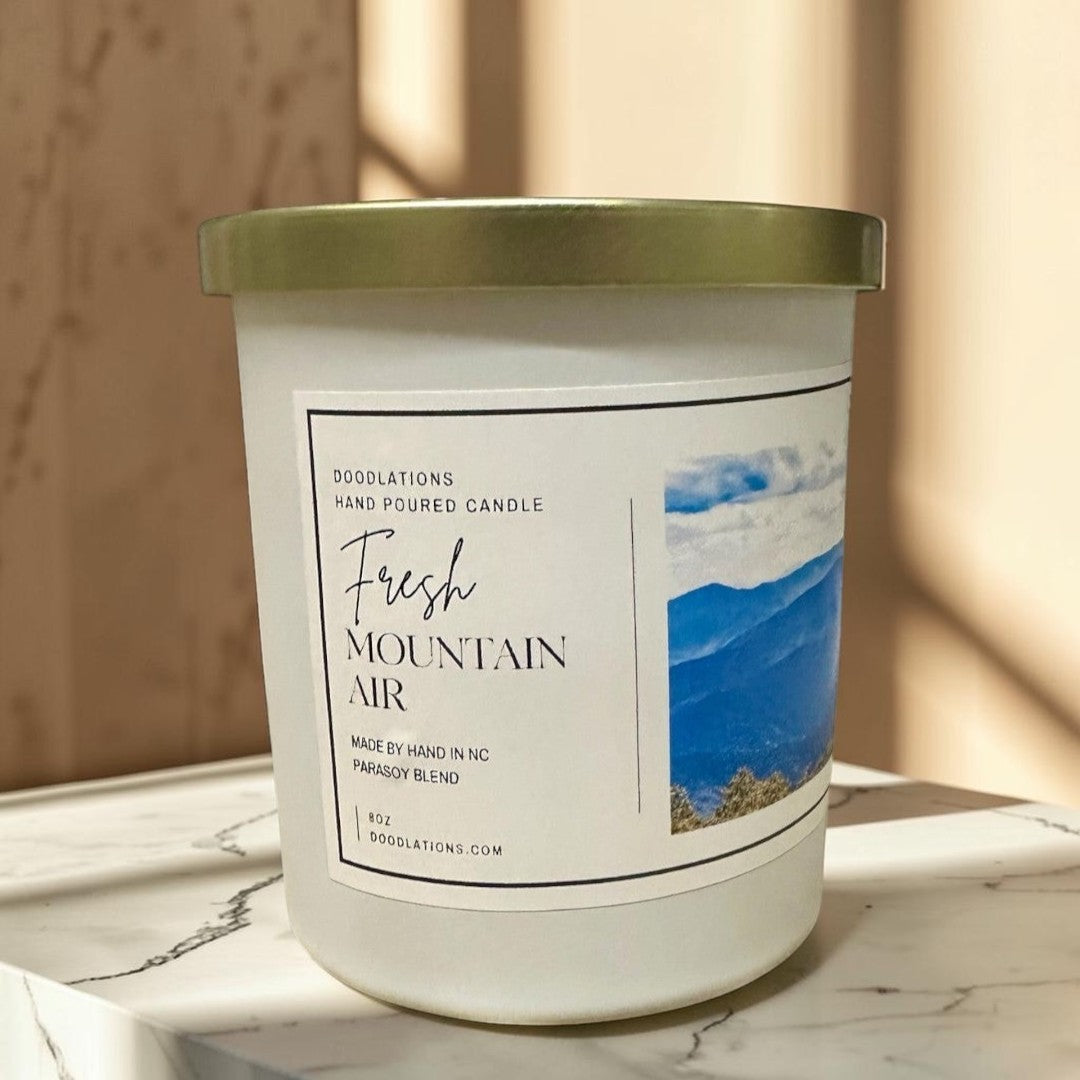 Fresh Mountain Air luxury hand-poured soy blend candle in white jar with gold lid.