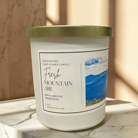 Fresh Mountain Air luxury hand-poured soy blend candle in white jar with gold lid.