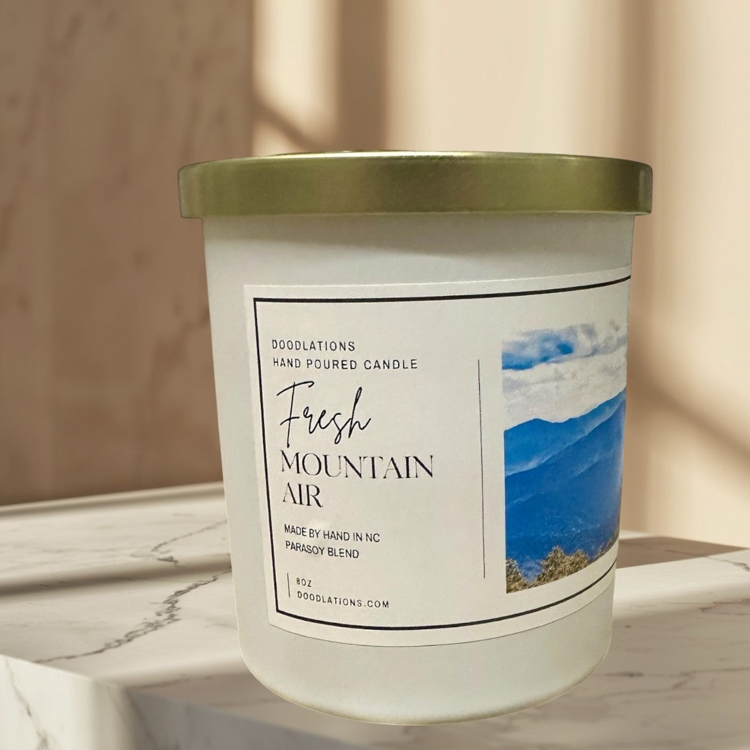 Fresh Mountain Air luxury hand-poured soy blend candle in white jar with gold lid.
