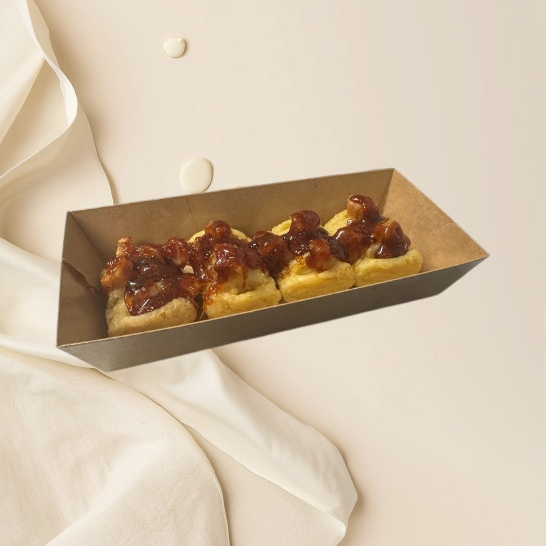 Hot Apple Pies wax melts in a brown paper tray, dusted with powdered sugar.