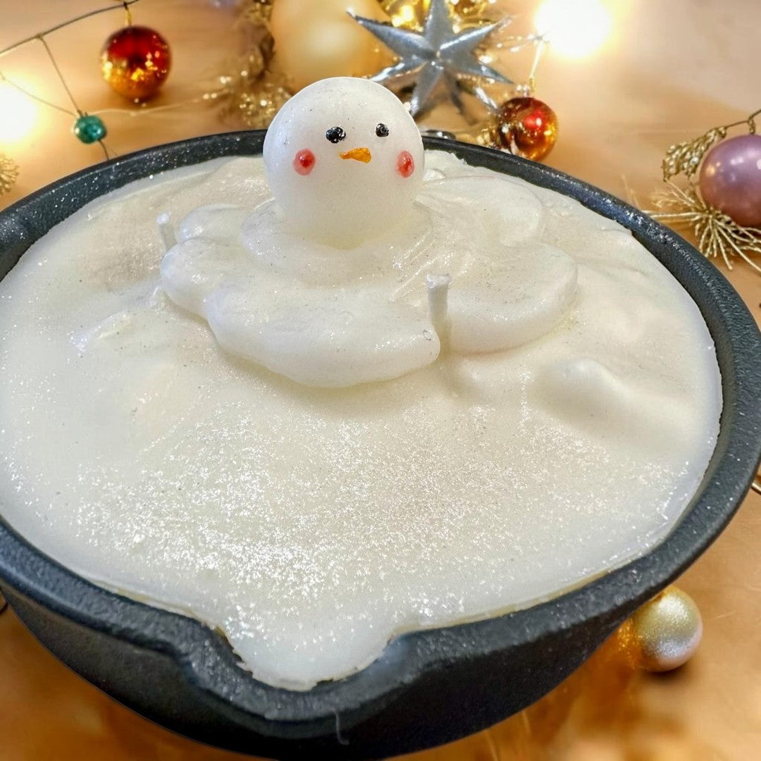 Melting Snowman Skillet candle featuring white wax and a melting snowman figure, perfect for holiday decor.