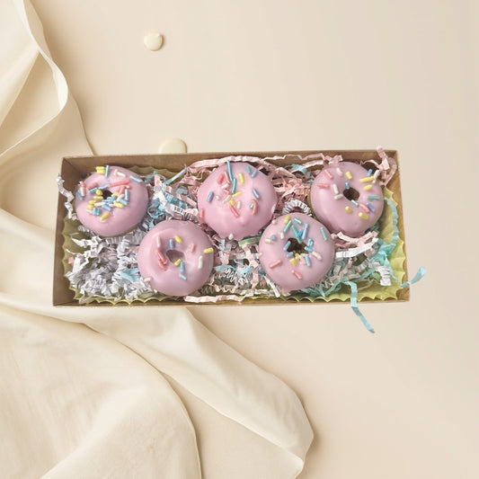 Strawberry pink strawberry glazed donut wax melts with colorful sprinkles in a gift box.