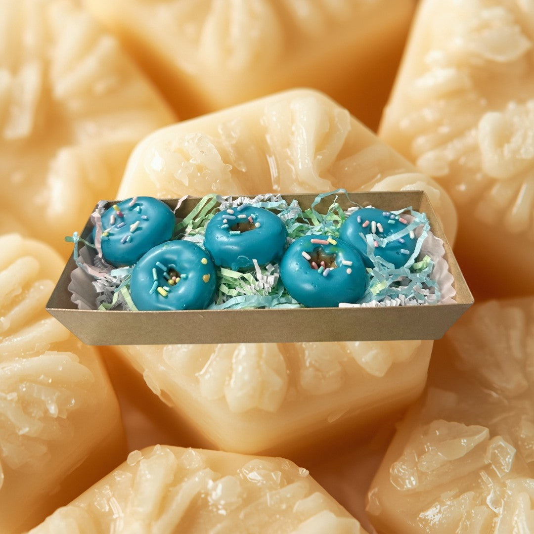 Fruit Loop blue glazed donut wax melts with colorful sprinkles in a gift box.