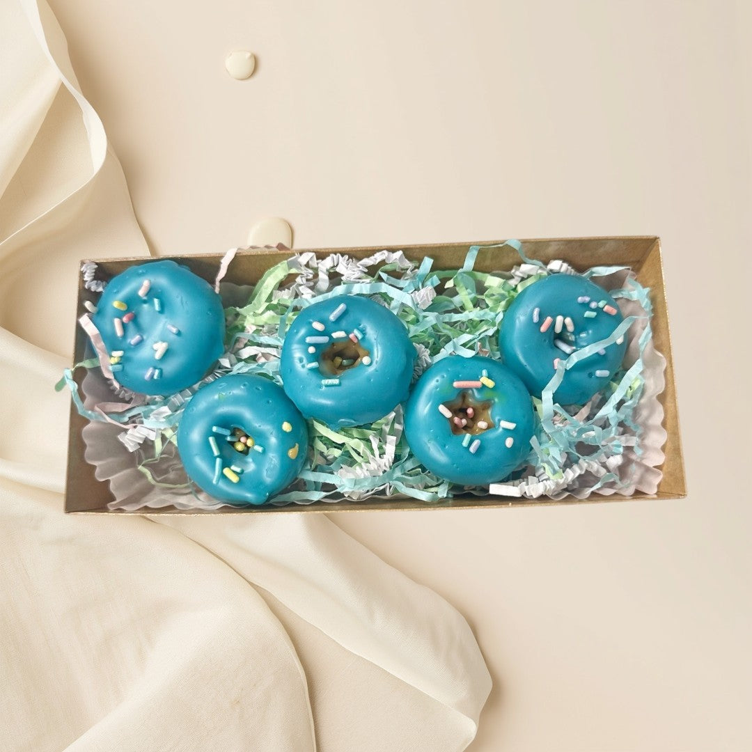 blue glazed donut wax melts with colorful sprinkles in a gift box.