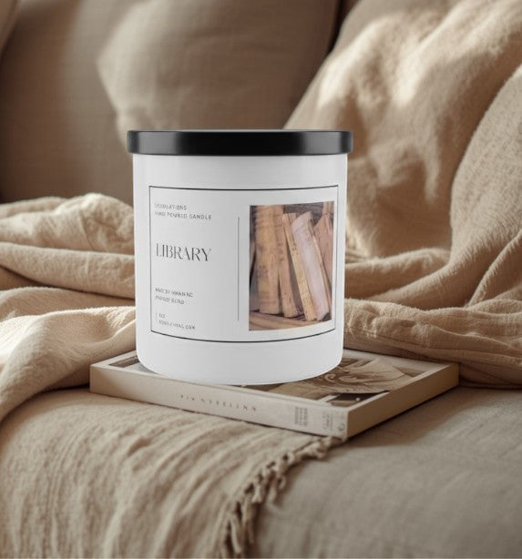 Library luxury boutique candle with a sophisticated woodsy scent, in a white jar with a black lid.