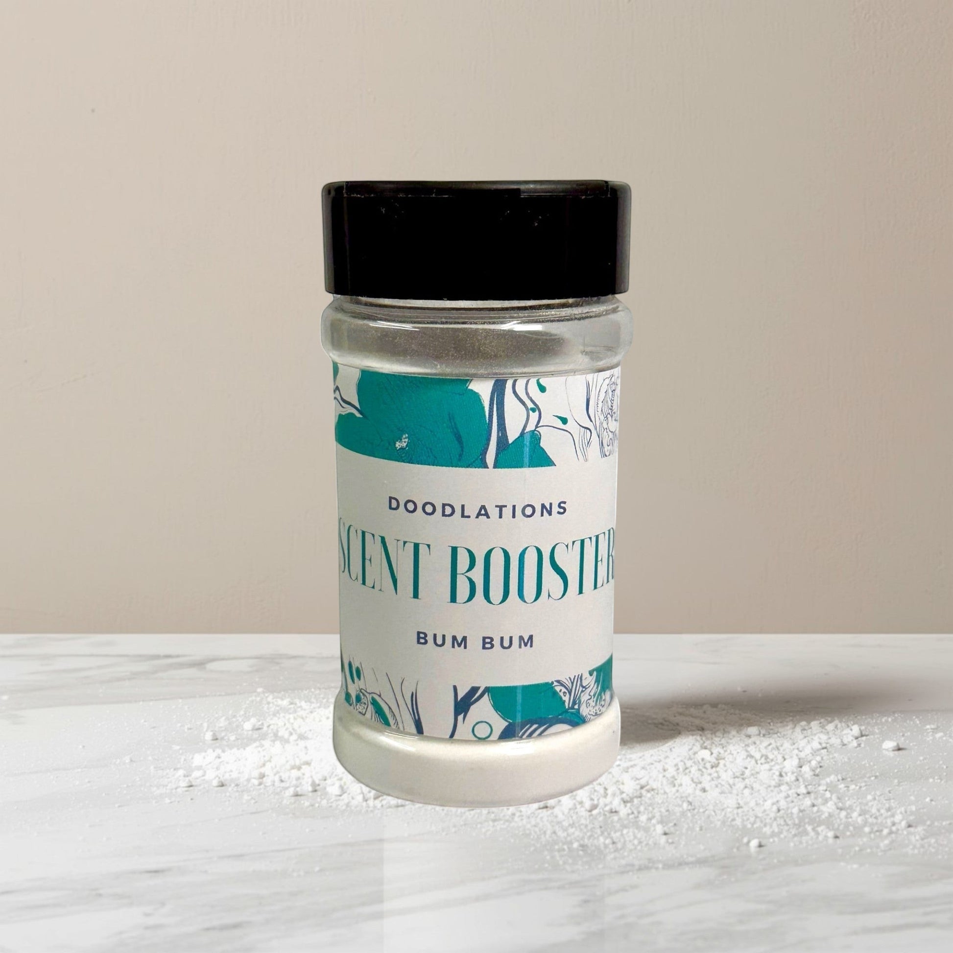 Doodlations Coffee Bar & Boutique Bum Bum laundry scent booster in a clear jar with a black lid. Tropical scent.