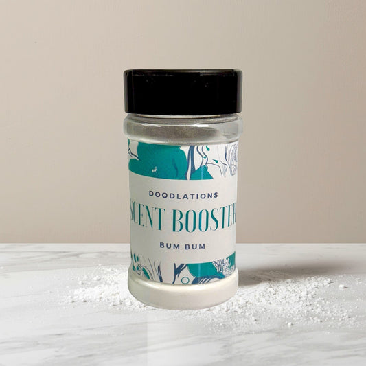 Doodlations Coffee Bar & Boutique Bum Bum laundry scent booster in a clear jar with a black lid. Tropical scent.
